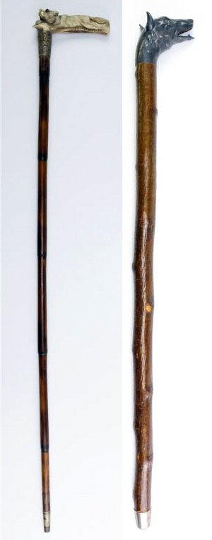 Pair of Animal Walking Stick Canes Dog and Fox: Collection of two fine antique walking sticks. The first is a cane with a carved bone handle in the form of a fox or wolf with glass eyes and a repousse and chased, marked sterling, silver band. Lastl