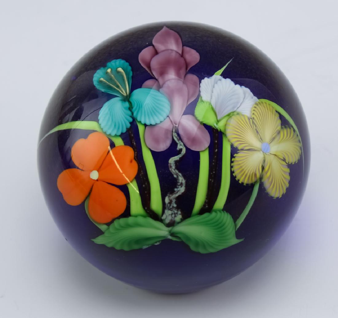 Orient & Flume Studio Art Glass Flower Paperweight: Guaranteed Authentic. Orient & Flume studio art glass paperweight. Features a spherical form with a multicolored bouquet of flowers, all on a cobalt blue ground and all cased in clear crystal. Measure