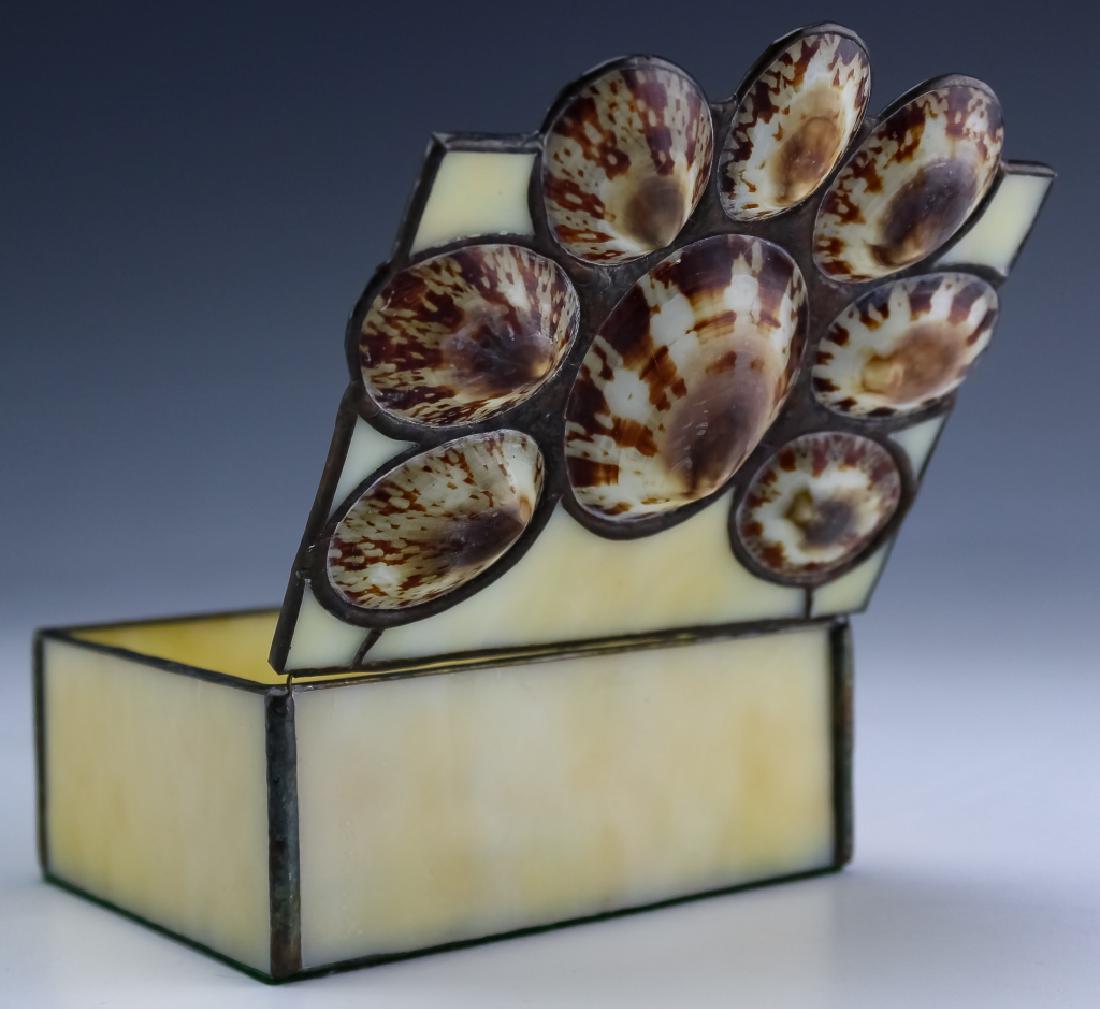 Nancy Grant Studio Leaded Art Glass Sea Shell Box: Guaranteed Authentic. Nancy Grant studio art glass box. Features ivory toned slag glass panels with the lid adorned with seashells. Signed Nancy 88. Measures 2 1/4" x 3 1/2" x 4 1/2". Comes with origi