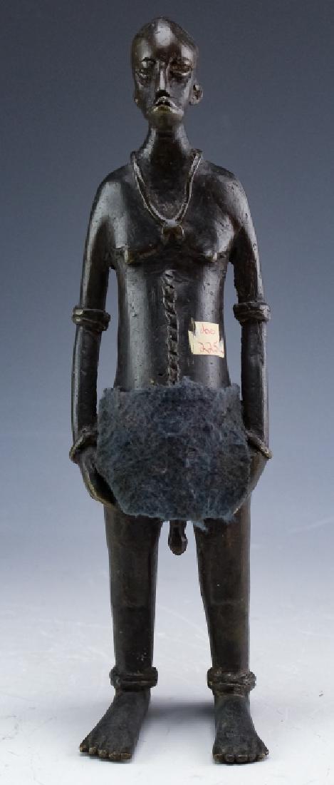 Benin African Bronze Tribal Figural Art Sculpture: Antique African bronze male figure. Artwork features a tribal man with well defined facial and body features. Good to fair overall condition having mild wear consistent with age. No found signatures n