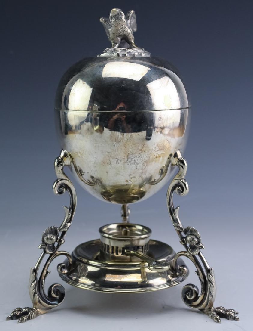Walker & Hall Silver Plate Bird Finial Egg Warmer: Walker & Hall silver plated egg warmer. Features a figural bird form finial with a body in the form of an egg. Opens to reveal a stand for four eggs. The base is footed with rooster form feet and a sh