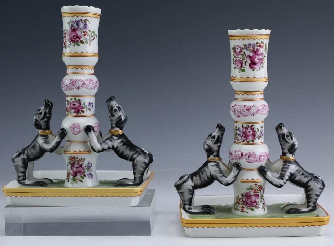 Pair Mottahedeh Dog Figural Porcelain Candlesticks: Stately Homes Sir Humphrey Wakefield porcelain candlesticks. Features a pair of candlesticks each decorated with a pair of figural black and white dogs with the base and body decorated with floral emb