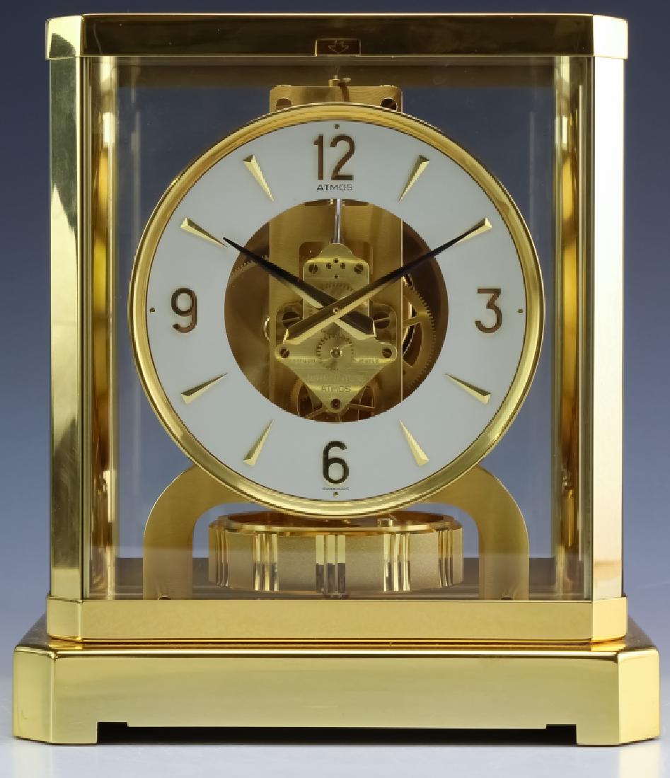 Jaeger Le Coultre Atmos Gold Case Mantle Clock: Jaeger LeCoultre brass and glass Atmos mantle clock. Circular dial and fifteen jeweled Swiss movement. Numbered "561267" on the top. Measures 9-1/4" x 8-1/4" x 6-1/2". Has not been tested for function