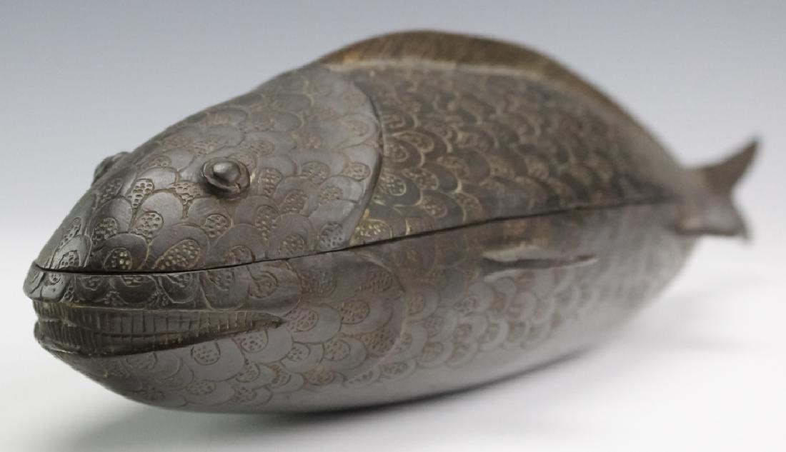 Antique Benin Kingdom African Bronze Fish Nut Box: Antique African bronze Kola nut container box from the Benin Kingdom. Crafted of cast bronze with a lovely patina. Fish shape with fitted lid. Bears old museum lettering on bottom. Measures 12 1/2" x