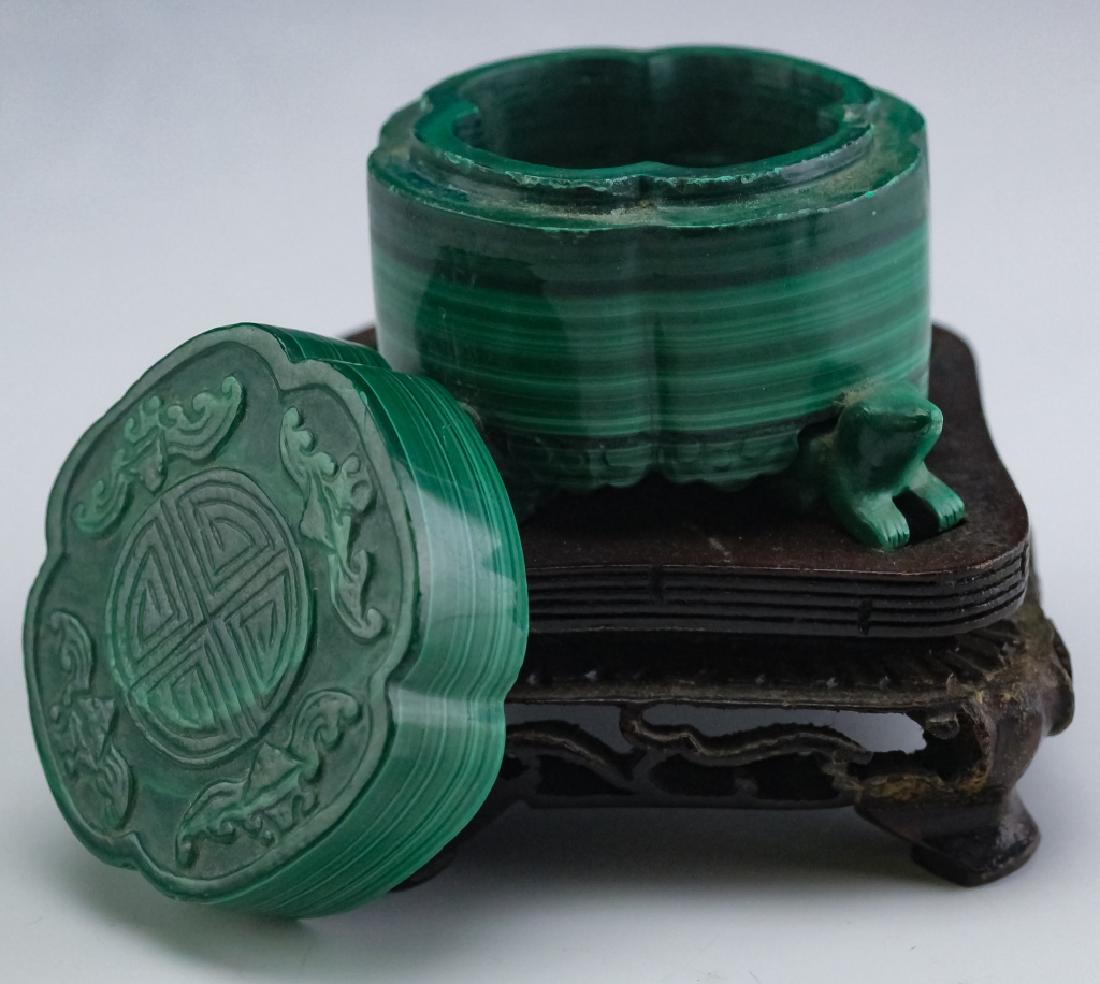 Chinese Export Hand Carved Green Malachite Box: Hand carved of green stripped malachite gem stone. Features lobed design resting on 4 carved figural frog feet. Top enhanced with good luck symbol and 4 bats in carved relief. Comes with fitted wooden