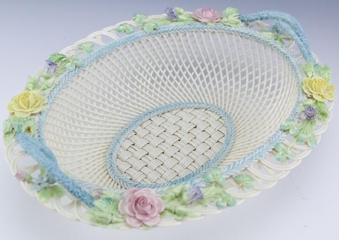 Belleek Irish Woven Porcelain Oval Floral Basket: Signed Belleek woven porcelain round basket. Crafted of fine quality Irish porcelain. Features floral border with rose, thistle and shamrocks. Wonderfully painted in pastel tones. Applied plaque signe