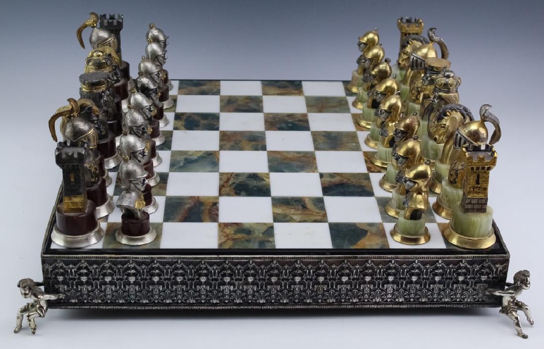 Giuseppe Vasari 1934-2005 Italy Complete Chess Set: Giuseppe Vasari (1934-2005) Italian. Guaranteed Authentic. Signed metal with gold gilt and onyx playing pieces and figural board. Sculptured pieces feature well defined battle ready figures with gold 