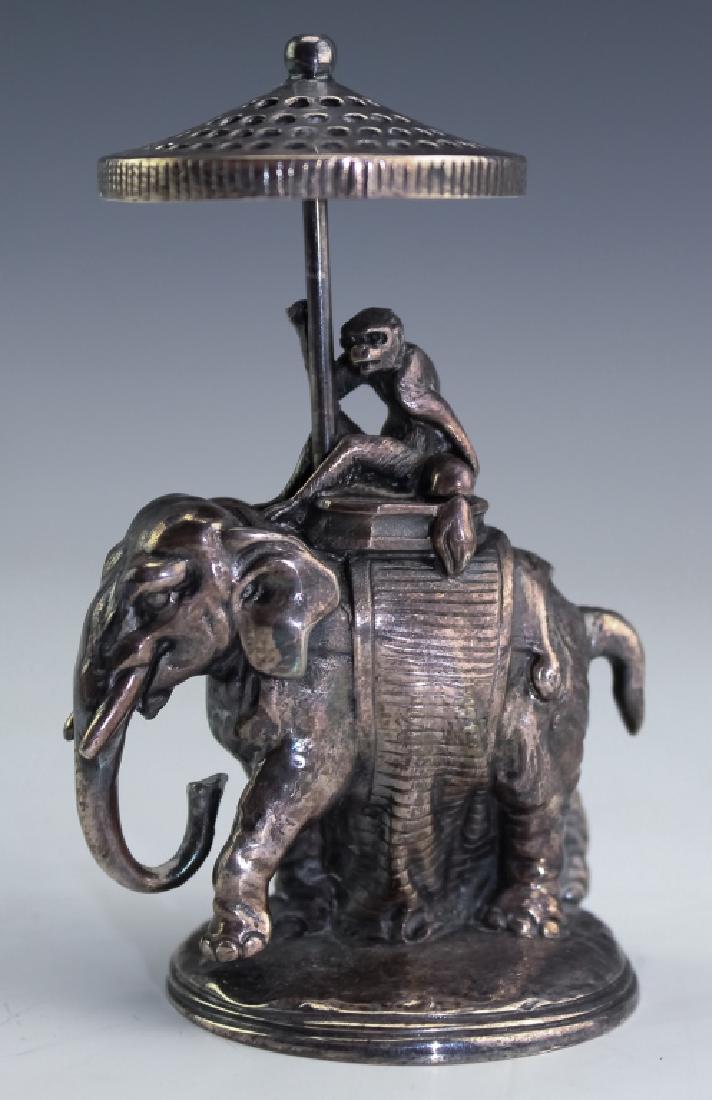 Christofle Silver Plate Elephant Toothpick Holder: Christofle French silver plated toothpick holder. Features a detailed rendition of an elephant with a monkey seated atop and holding a reticulated umbrella. Marked on circular base and reads Christofl