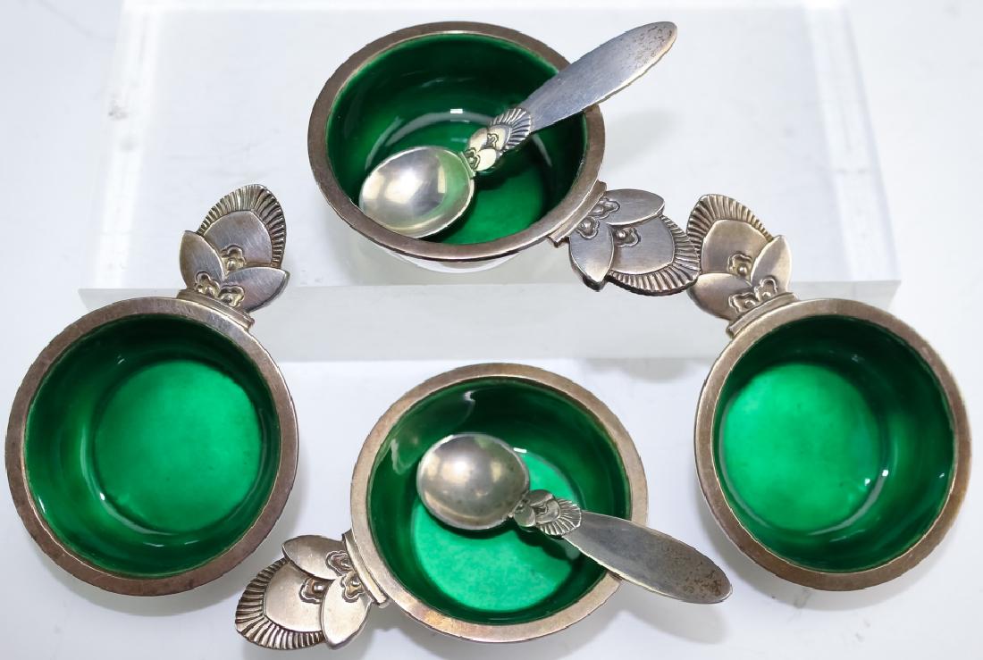 Georg Jensen Sterling Silver Salt Cellars w Spoons: Georg Jensen sterling silver and enamel salt cellars and two spoons. Guaranteed Authentic. Features four salt cellars in the acorn pattern with emerald green enamel in the bowls. Measures 5/8" x 2 1/2