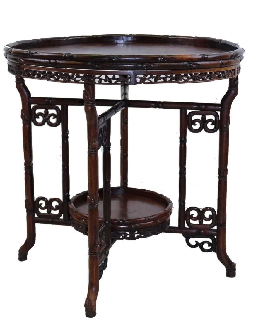 Chinese Carved Wood Bamboo 28" Form Folding Table: Chinese circular hard wood Bamboo folding table. Features a removable 27 1/2" diameter circular table top that rests on a folding set of four legs. The segments are all decorated in bamboo form with a