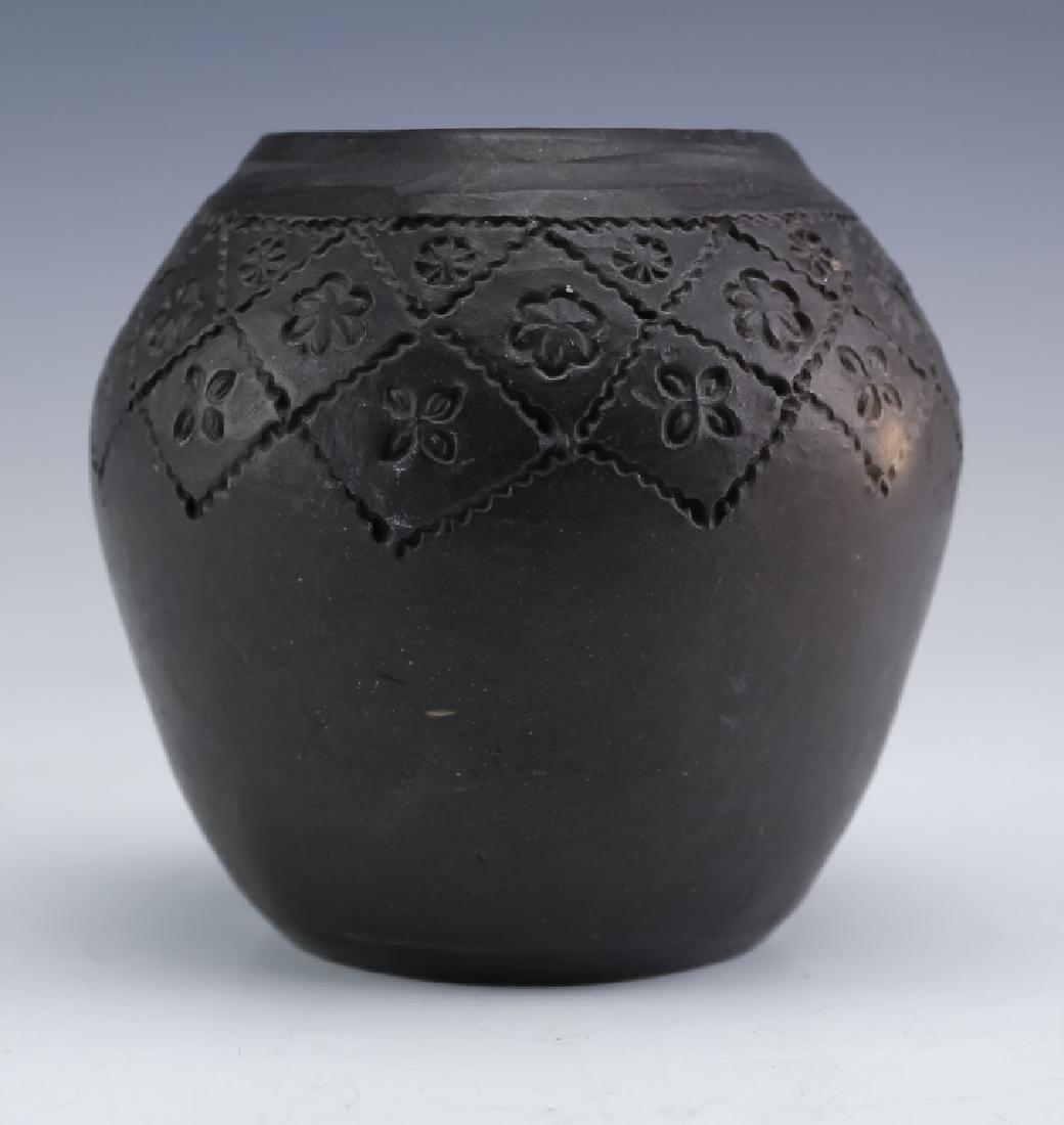 Bigmeat American Cherokee Indian Art Pottery Vase: Native American Cherokee Indian vase made by Bigmeat. Guaranteed Authentic. Features a bulbous squat form with impressed decoration on black ceramic. Measures 4 1/4" x 4 1/2". Signed base "Made by Big