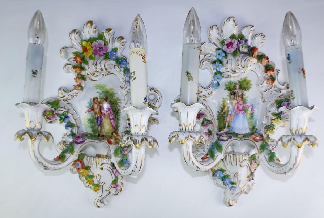 Fine Antique Dresden German Porcelain Wall Sconces: Antique Dresden wall sconces. Features a raised floral motif throughout the sconce as well as in the pair of electrified arms. Dresden mark on reverse. Measures 15" x 10" x 10". Good overall condition
