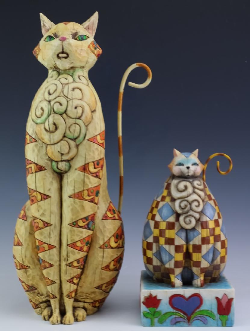 Jim Shore Pair of Whimsical Cat Kitten Sculpture: Pair of cat figurines. One is in the form of a plump checkered cat seated on a heart and floral base. Measures 10" x 5 1/4" x 5 1/4". The second features a taller seated cat with scrolled diamond patt