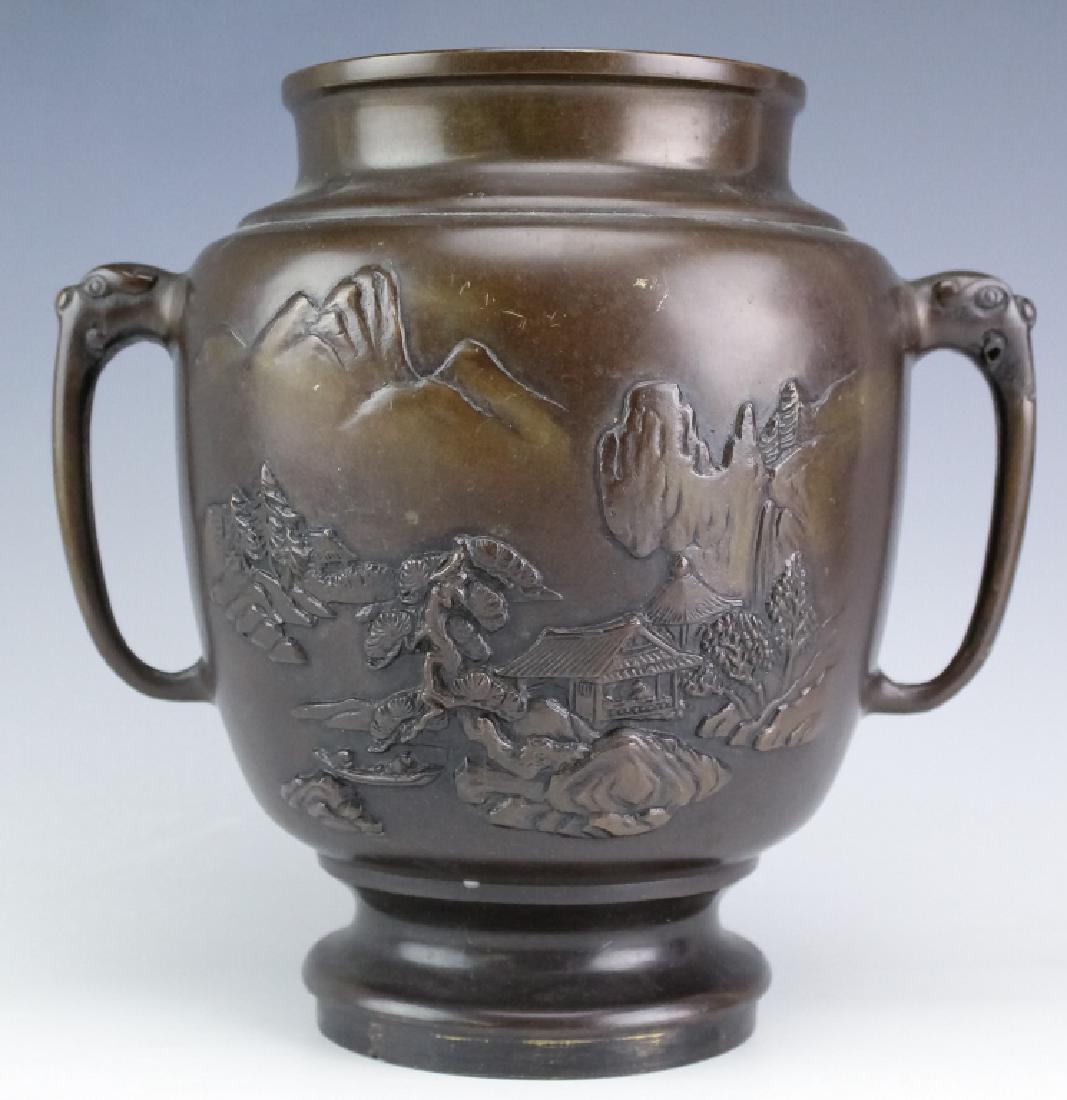 Japanese Meiji Bronze Village Scene Vase Censer: Beautiful Japanese censer crafted of cast bronze with warm brown patina. Features a double handle design with low relief scene of a mountain village. Appears to be missing a base, no bottom. Measures 