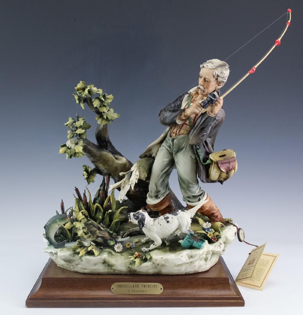 Capodimonte Porcelain Principe Il Pescatore Figure: Capodimonte Porcellane Principe porcelain figurine. Features the form titled "Il Pescatore". Depicts a scene of an old man fishing with a fish at the end of his reel. Measures 14" x 11 1/2" x 9". Good