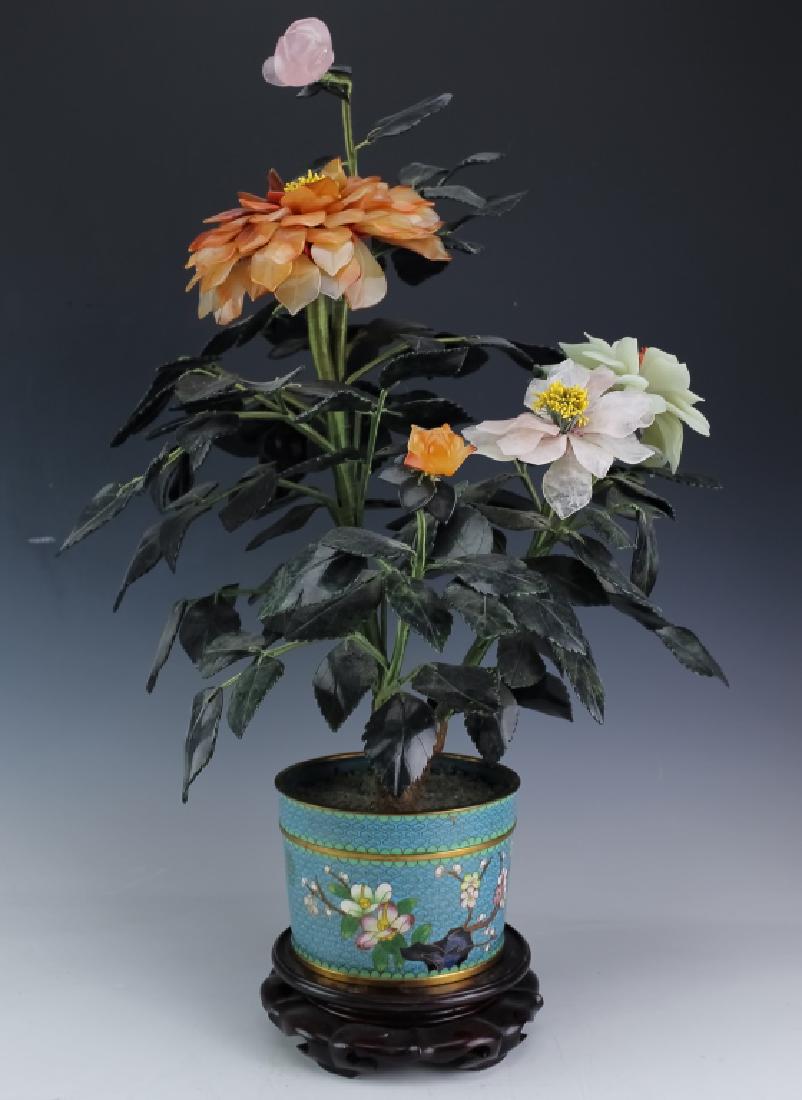 Chinese Floral Jade Tree w/ Cloisonne Flower Pot: Vintage Chinese export Jade tree. Cloisonne enamel base mounted with floral designed "tree". Each petal or leaf is hand carved from gemstones including spinach jade, rose quartz and carnelian. Each is