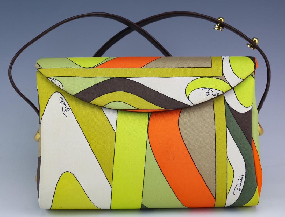 Emilio Pucci Abstract Silk & Leather Purse Handbag: Vintage Emilio Pucci silk handbag. Features an abstract silk exterior with adjustable leather strap with heavy gold tone hoops at each end. Measures 5 1/2" x 8" x 2 1/2". Signed on interior. Good over
