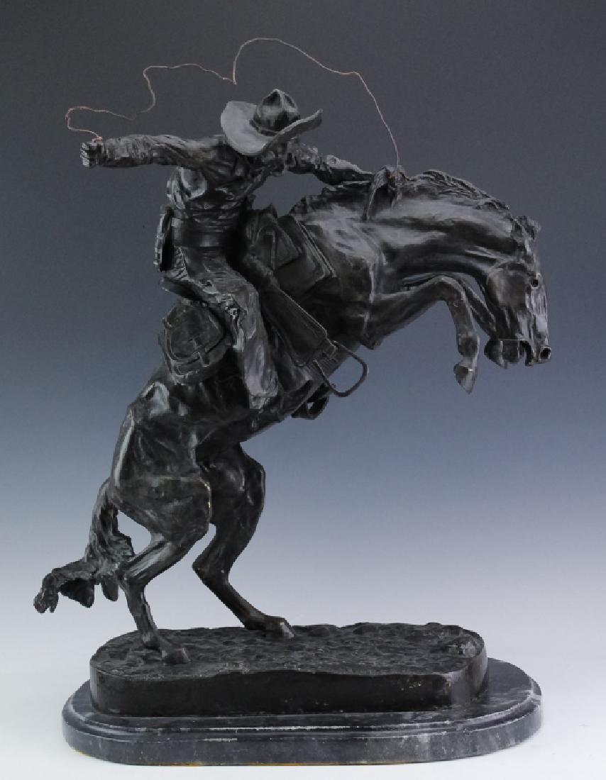 Remington American SW Cowboy Bronze Art Sculpture: After Frederic Remington (1861 - 1909) American. 20th Century. American Western cowboy on horse bronze sculpture. Figure depicts an American cowboy with lasso in hand and the horse bucking on it's hin