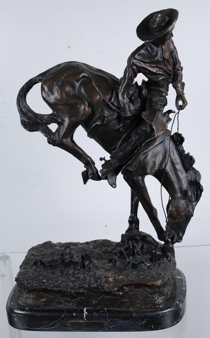 Remington American "Outlaw" Bronze Art Sculpture: After Frederic Remington (1861 - 1909) American, Circa later 20th Century. Bronze statue. Features the work titled: Outlaw. Depicts a rider on horseback being bucked by his horse. Fixed to marble base