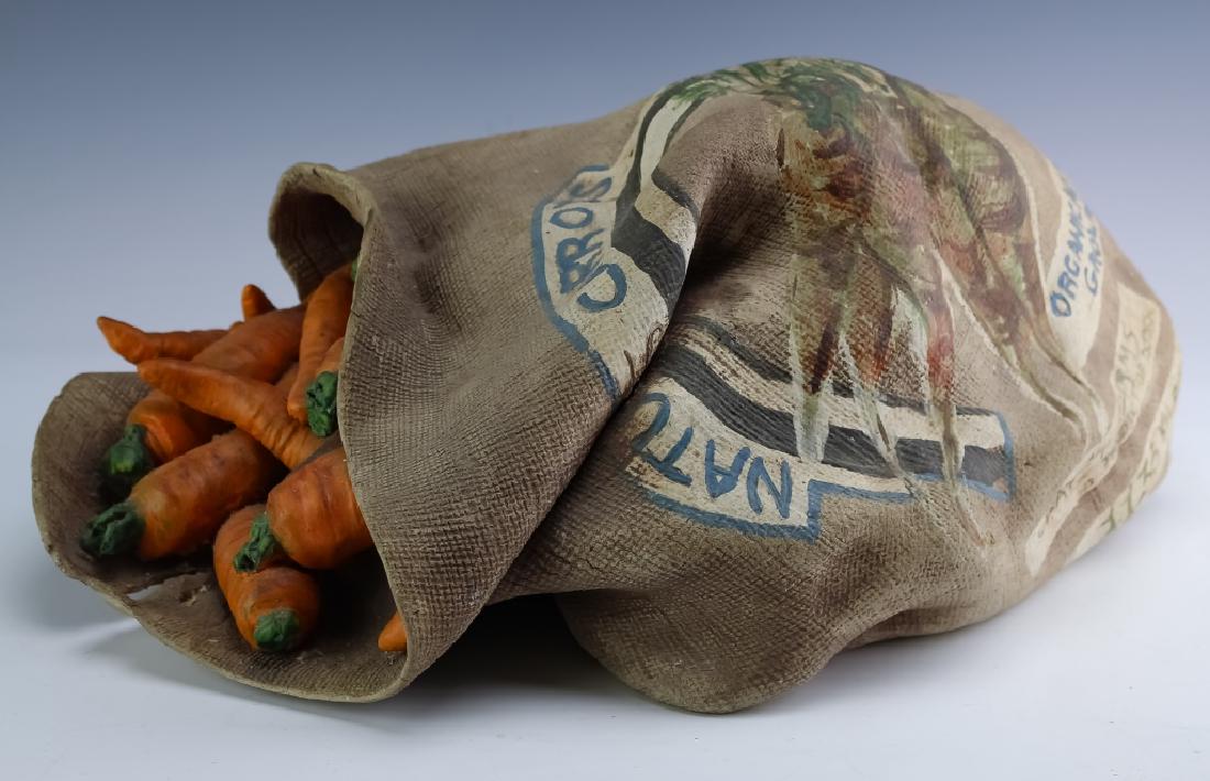Studio Art Pottery Trompe L'Oeil Carrot Bag Statue: Mystery artist studio art pottery hand crafted bag of carrots sculpture. Realistically detailed to fool the eye. Artwork depicts a burlap style bag spilling out carrots. Labeled Organically Grown Clay