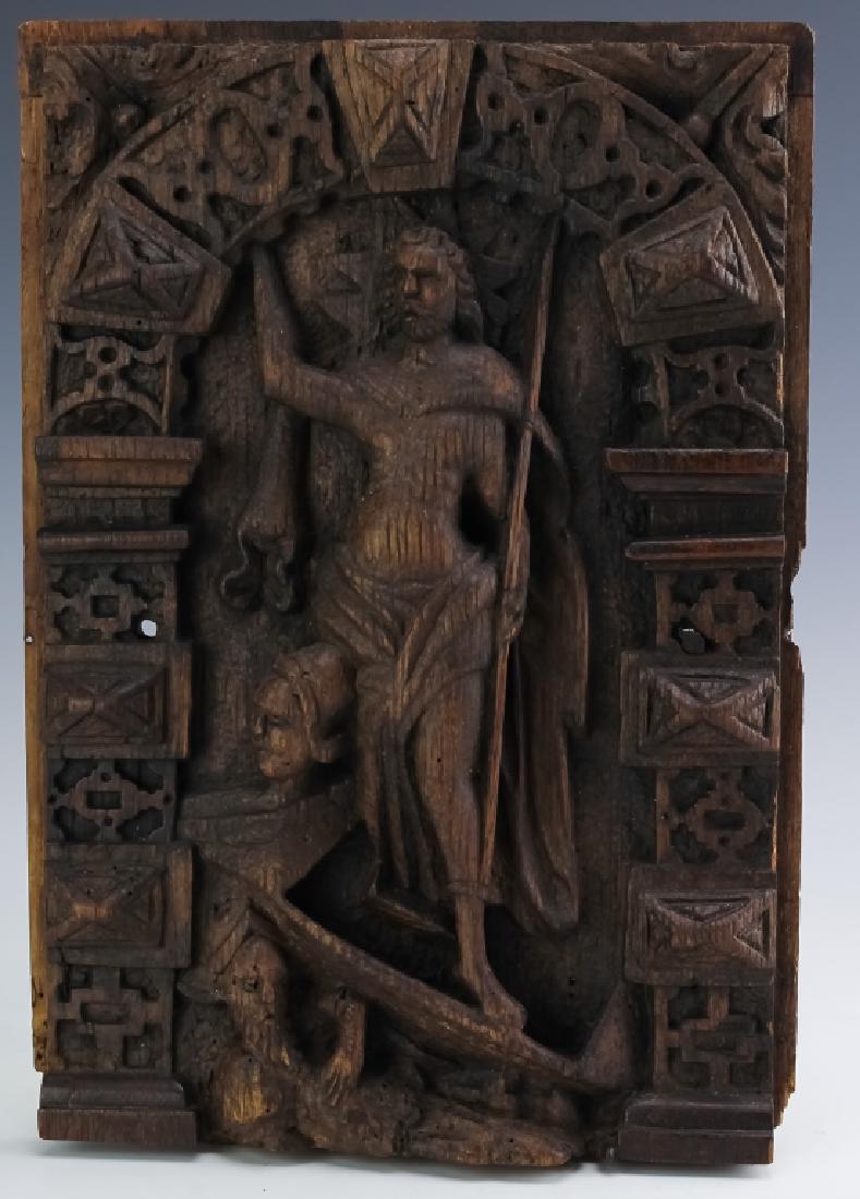 Antique Carved Wood Dutch Relief Panel Decoration: Antique carved wood relief panel carving. Features the form of a man in drapery with a spear and halo behind his head. near the bottom are a pair of helmeted soldiers. Bordered with arched geometric p