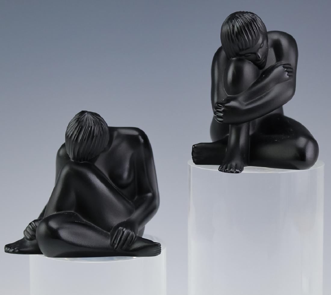 Lalique French (2) Noir Art Glass Figure Sculpture: Pair of female nude sculptures by Lalique. Crafted of fine quality French art glass crystal in Noir black. Figures feature two versions of the "Venus" design. Signed Lalique France. Tallest measures 2