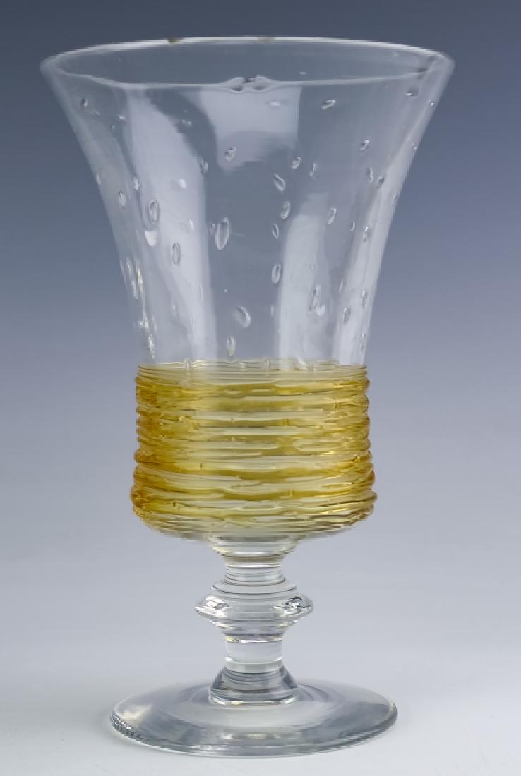 Stuben Attributed Captured Bubble & Thread Glass: Fine piece of art glass attributed to Steuben. Features a wide mouth and deep bowl with captured bubble and golden colored pulled glass thread around the base. Unmarked. Measures 6 1/4" x 4". Good ove