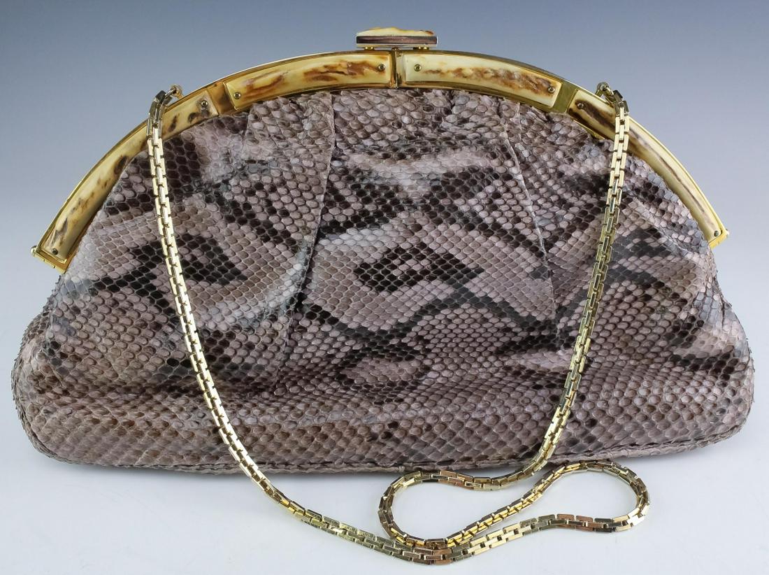Judith Leiber Minaudiere Snake Skin Clutch Handbag: Vintage Judith Leiber designer snake skin handbag purse. Features top quality snakeskin with natural bone inlay. Lined with soft satin. Strap drop measures 14". Measures. Signed Judith Leiber. Dust ba