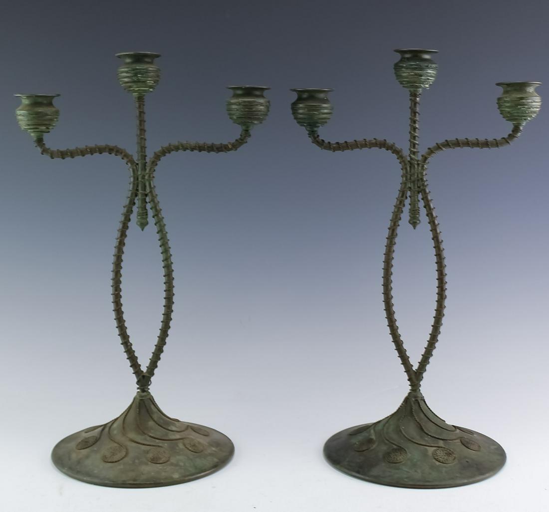 Pair Riviere Studios Patinated Bronze Candelabras: Early 20th century Riviere Studios patinated bronze candelabras with S-form arms on a spreading conical base with three urn-form bobeches. Decorated with entwined wire coils. A contemporary style of T