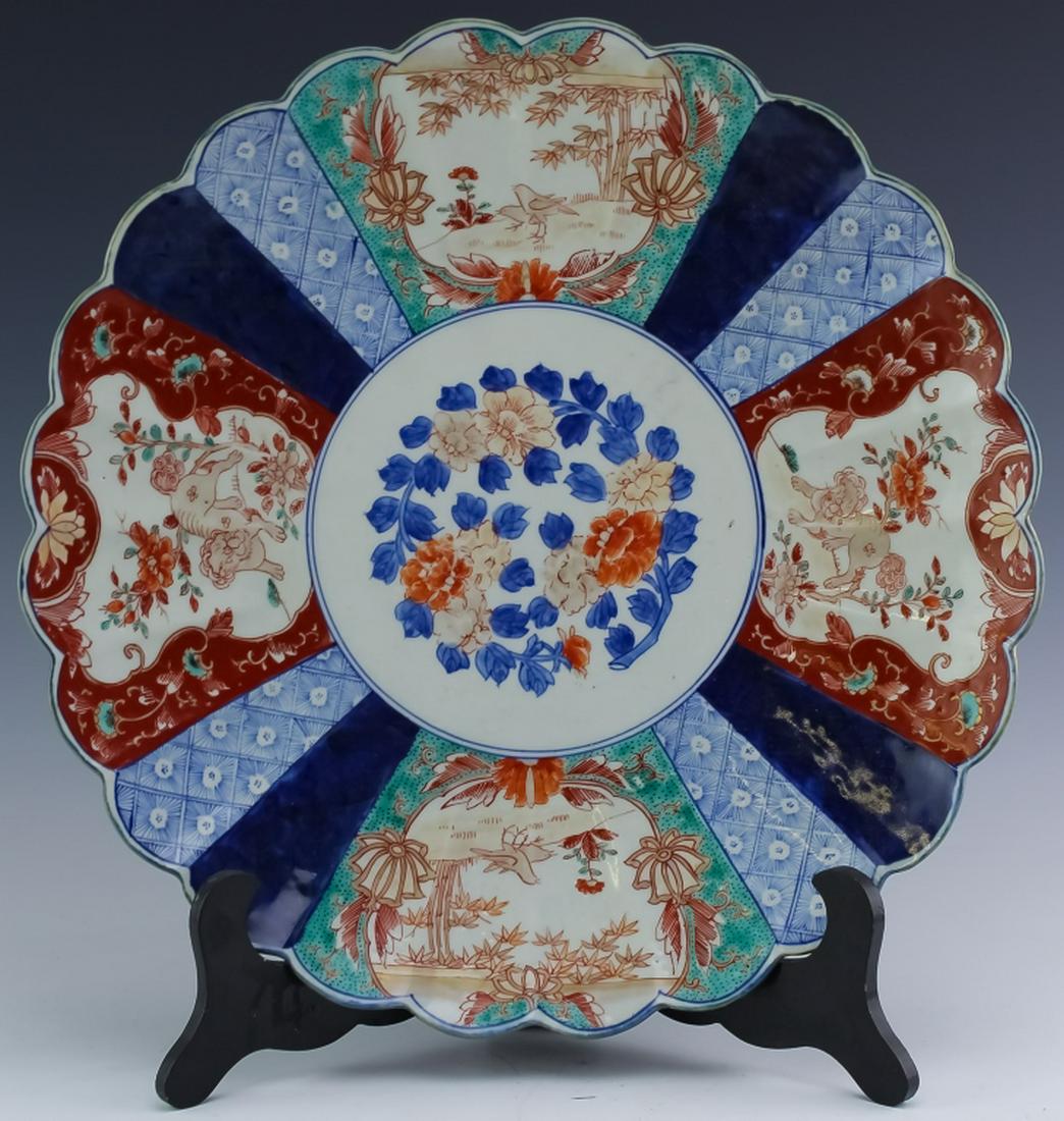 Japanese Meiji Period 16" Porcelain Charger Plate: Antique 19th to early 20th century. Crafted of fine quality Japanese porcelain in the Meiji period. Centered with a floral design encircled by three reserves of foo dogs and birds on floral landscapes