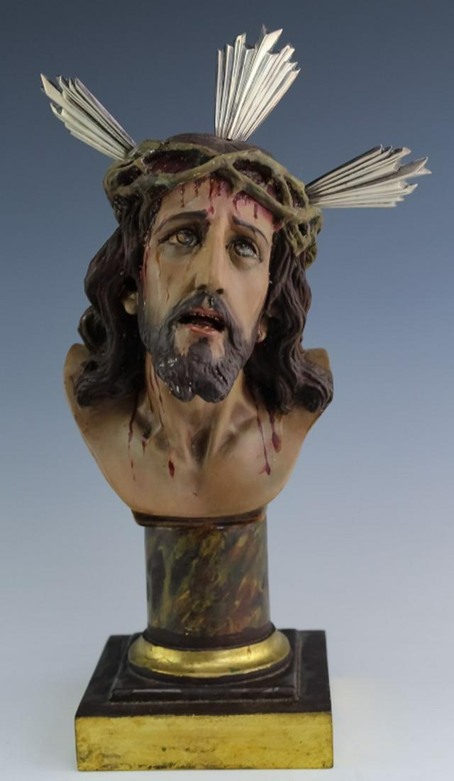 Jesus Christ w/ Crown of Thorns Sterling Halo Bust: Bust of Jesus Christ. Crafted from plaster and decorated with polychrome paint this rendition of Jesus has him wearing the Crown Of Thorns with sterling silver segments acting as a halo. Measures 13"