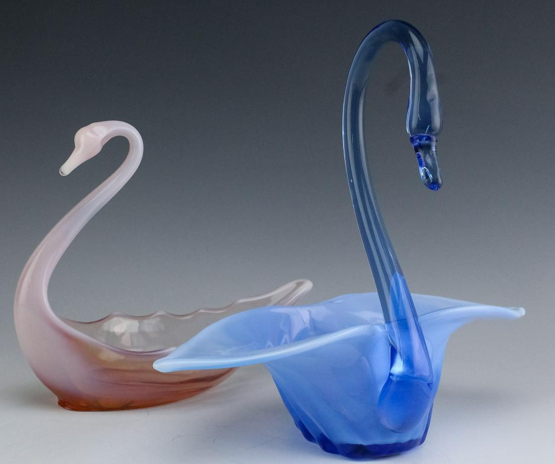 Pair Duncan Miller Pink & Blue Opaline Glass Swans: Pair of Duncan & Miller pink and blue opaline swan centerpieces. Crafted from soft pink glass as well as blue and white glass. Measures 10 1/2" x 12" x 5" and 8" x 9" x 3 1/2". Unmarked but attributed