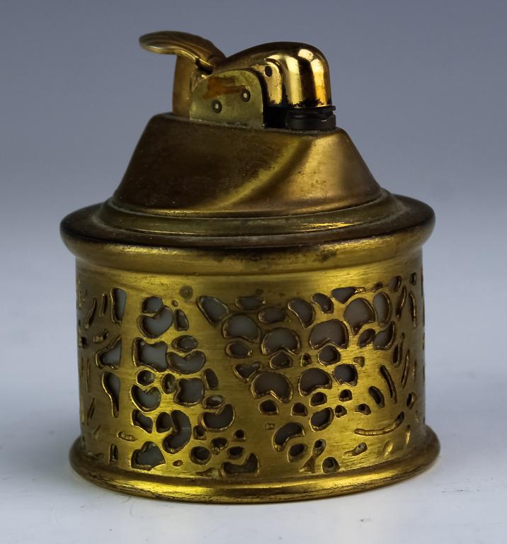 Tiffany Studios Bronze Grapevine Art Glass Lighter: Guaranteed Authentic Rare signed Tiffany Studios grapevine pattern desk lighter. Crafted of gold gilt bronze with caramel color art glass insert. Signed Tiffany Studios New York 981. Measures approxim