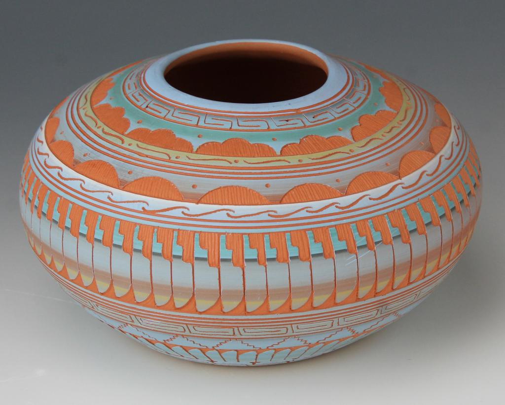 Hilda Whitegoat Native American Navajo Vase Pot: Studio art pottery vase by Native American Navajo Indian artisan, Hilda Whitegoat. Features etched imagery consisting of traditional forms like features, mountains, hills and clouds with polychrome de