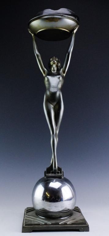 Antique Art Deco Figural Nude Female Ashtray Stand: Art Deco cigarette smoking ashtray stand. Patinated metal figural nude female on top of a chrome orb sphere. Comes with round ceramic black ashtray insert. Measures approximately 25" in height. Good c