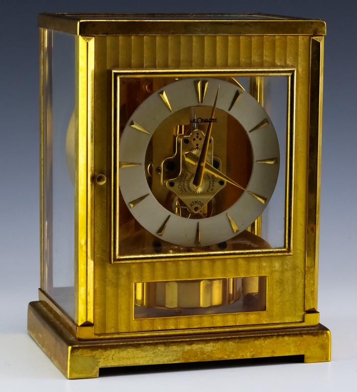 Vintage Jaeger LeCoultre Atmos Swiss Mantle Clock: Jaeger LeCoultre Atmos clock. Features a rectangular gilt brass mantel clock wound by barometric pressure changes. Glazed on five sides. Serial number 67227. Good condition with surface scratches on b