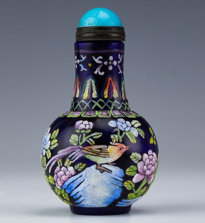 Antique Chinese Enameled Peking Glass Snuff Bottle: Antique 19th to early 20c Chinese snuff bottle. Crafted of cobalt blue glass. Richly enameled with flowers, butterflies and exotic bird decoration. Blue glass jewel topped dipper. Signed with a four c
