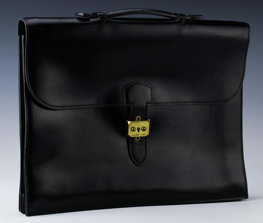 Hermes French Leather Sac a Depeches Briefcase Bag: Guaranteed Authentic Black Hermes glossy leather Sac a Depeches briefcase attache case. Featuring gold toned hardware, flap top handle & fold over top with twist-lock closure. Suitcase has spacious in
