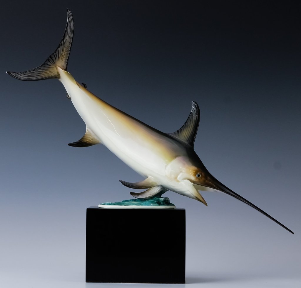 Royal Worcester Porcelain Swordfish Fish Figurine: Royal Worcester porcelain fish figurine. Features hand painted decoration over the form of a swordfish. Measures 14 3/4" x 16" x 4 1/2". Marked on base. Comes with wood stand. Good overall condition w