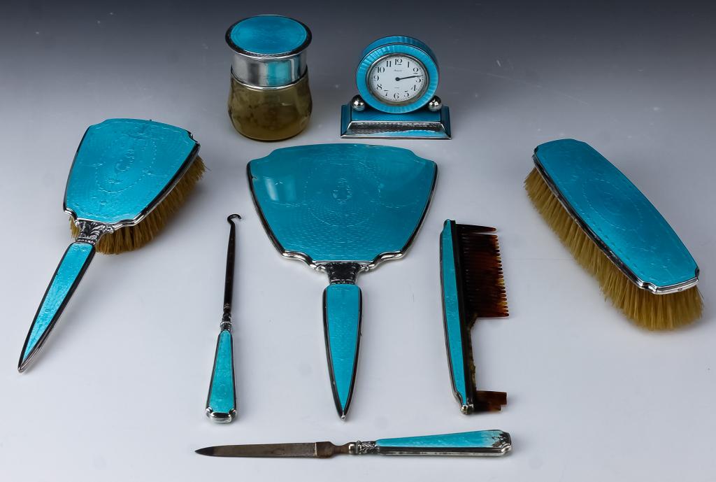 Sterling Silver Blue Enamel Guilloche Vanity Set: Fine antique sterling silver vanity set with clock. All pieces are decorated with blue enamel over sterling silver guilloche. Comes with two brushes, damaged comb, nail file, button hook, mirror, lidd
