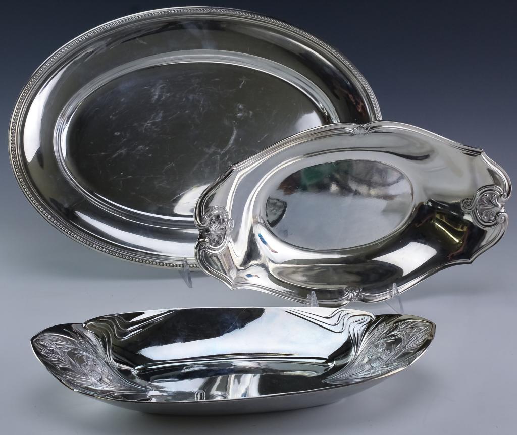 Lot 3 Christofle Silver Plated Centerpieces & Tray: Collection of three French Christofle silver plated items. Features an art nouveau and neoclassical styled ovular centerpiece. Each measures approximately 13 1/2" x 2" x 7 1/2". Lastly comes with an o