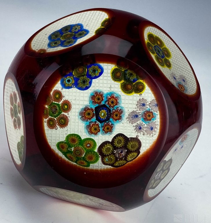 Clichy Faceted Art Glass Millefiori Paperweights: Fine French crystal paperweight. Features red cut to clear peering inside to clusters of millefiori cane. Cross hatched etched base. Measures 3 1/8" x 3 3/4". Good overall condition with no damage to