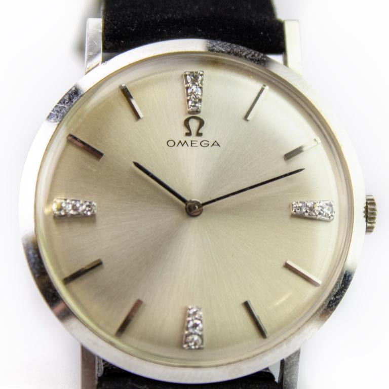 Vintage Omega 14k White Gold & Diamond Men: Vintage men's Omega Swiss watch. Features a diamond enhanced silver sunburst dial, 17 jewel 620 caliber movement. Case measures 33mm not including crown. Signed Omega on case, dial and movement. Marke