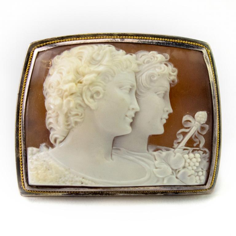 Very Fine Antique 14k & Silver Carved Shell Cameo: Antique carved shell cameo. Features a pair of busts with bow tied scepter with floral and grape motifs. Carved from shell. Unmarked but tested 14k and silver. Functioning pin back. Measures 1 3/4" x 