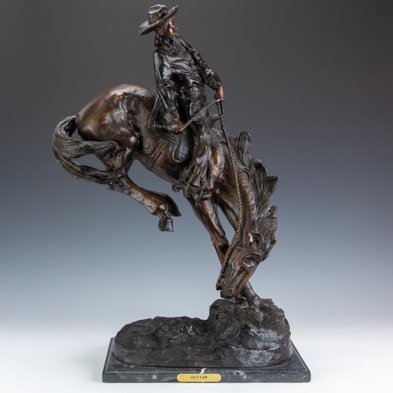 after Remington Bronze Outlaw Statue Cowboy Horse: After Frederic Remington (American, 1861-1909) Bronze cowboy on horse sculpture, titled "Outlaw". Statue on marble base with title on gilt plaque. Artist signature on base of bronze. Sculpture: 25 1/2