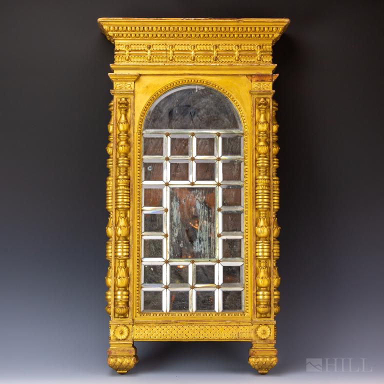 Antique European Gold Gilt Framed Arch Top Mirror: Comprised of demilune beveled mirror over a grid of smaller beveled mirrors held in place with decorative nail heads. Ornate frame with gold gilt finish. Mirror approximately 29 1/2 in. x 16 in. Fair 