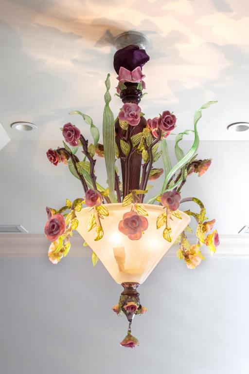 Colorful Murano Art Glass Floral Basket Chandelier: Designed as a basket or pot of flowers in pink and green colored Murano Italian art glass. Measures approx. 43 in. high x 23". Good condition with mild surface wear. Images were taken in the Palm Beac