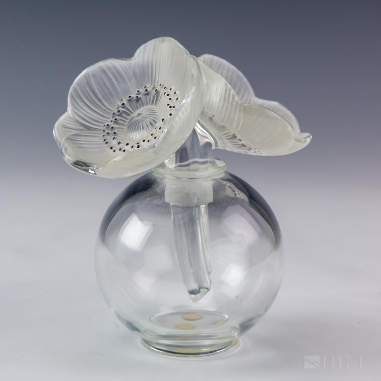 Lalique Crystal Les Anemons Flower Perfume Bottle: Vintage Lalique crystal Les Anemons flower perfume bottle. Featuring clear round smooth crystal body, and double frosted crystal floral stopper with black enamel accents. Both stopper and underside of