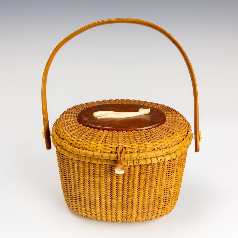 Vintage Woven Nantucket Style Basket Whale Purse: Vintage hand made basket from Nantucket with carved whale bone decoration on the lid. Measures 6 1/2" x 9 1/2" x 7". Unsigned. Good overall condition with minor wear. Hill Auction Gallery in house USA