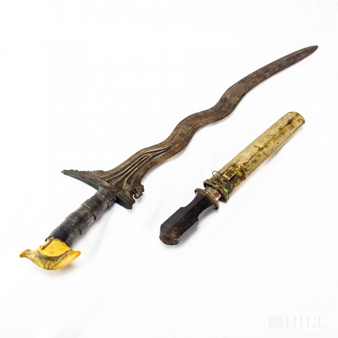 Lot 2 Indonesian Kris Knife Sword w/ Small Dagger: Small Japanese sword and Indonesian Kris dagger. Dagger featuring repousse floral pattern handle, top of handle made of hand carved raw material. Curvilinear steel blade. Small dagger with silver colo